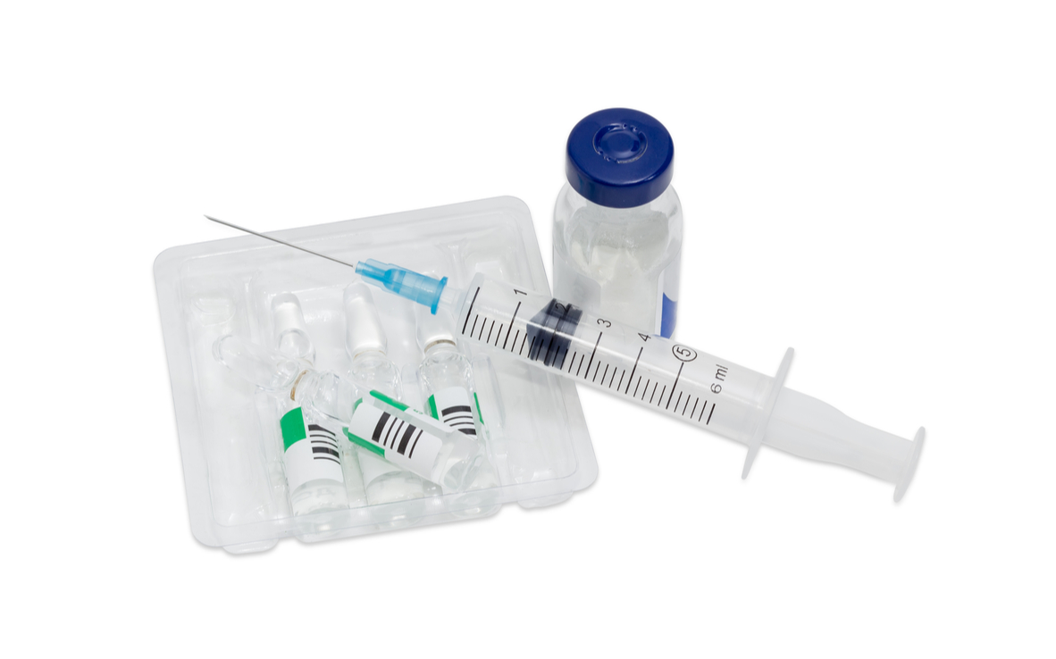 stock-photo-disposable-plastic-medical-syringe-with-hypodermic-needle-one-crimp-vials-and-several-ampules-with-530949793